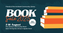 Six books are stacked to the right of information about the Library's annual book sale