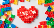 LEGO pieces scattered with a red heart created out of LEGOs in the middle